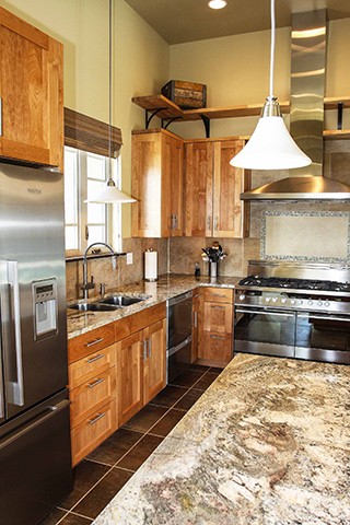 A kitchen with stone and wood designs