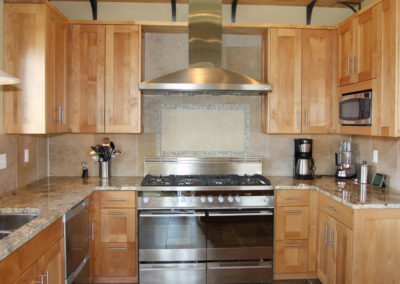 A wooden cabinetry and metal appliances